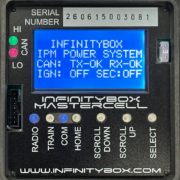 Close-up of the Infinitybox MASTERCELL NGX with the cover removed, showing the inSIGHT LCD screen displaying CAN and ignition status, CAN HI/LO indicator lights, serial number, output fuse, and menu navigation buttons.