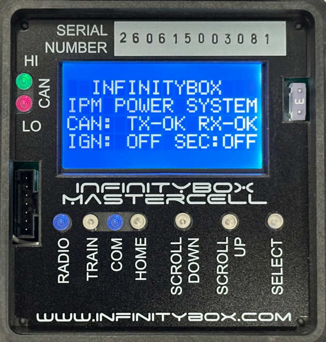 Close-up of the Infinitybox MASTERCELL NGX with the cover removed, showing the inSIGHT LCD screen displaying CAN and ignition status, CAN HI/LO indicator lights, serial number, output fuse, and menu navigation buttons.